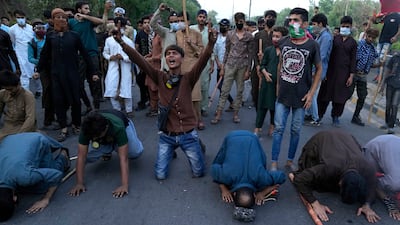 Khan supporters celebrate the Supreme Court's decision in Lahore. AP