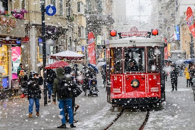 A tram runs along Istiklal Avenue in Istanbul in falling snow. The weather is playing havoc with the city's transport system. AFP