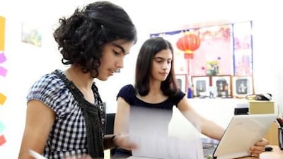 Line Dalile, 13, left, and her sister Boushra, 15, who live in Ajman, say they do most of their daily assignments on their laptops at home.