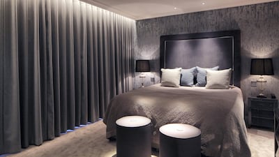 Soft lighting sources, muted linens and curtains are one way to make your bedroom feel more restful when you turn in. Photo: John Cullen Lighting