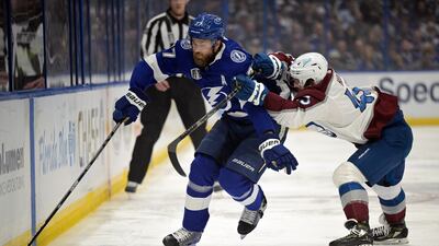 Tampa Bay Lightning defenseman Victor Hedman (77) controls the puck next to Colorado Avalanche center Darren Helm (43). AP Photo