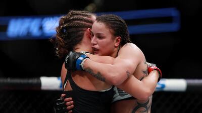 Miesha Tate of the United States, left, embraces Raquel Pennington of the United States after her unanimous decision defeat in their women’s bantamweight bout. Michael Reaves / Getty Images