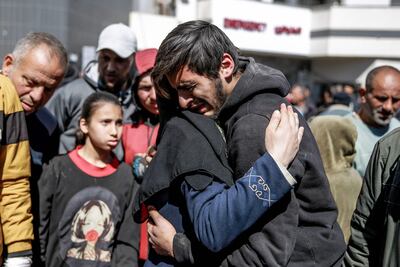 People mourn following an early morning incident when Israeli forces opened fire on crowds rushing at an aid distribution point in Gaza City on February 29, 2024. AFP