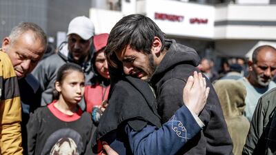 People mourn the deaths of more than 100 people, after Israeli forces opened fire on crowds at an aid distribution point, in Gaza City, on Thursday. AFP