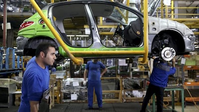 Iranian car workers assemble a Peugeot 206 at the state-run Iran-Khodro automobile manufacturing plant near Tehran, Iran. Ebrahim Noroozi / AP Photo