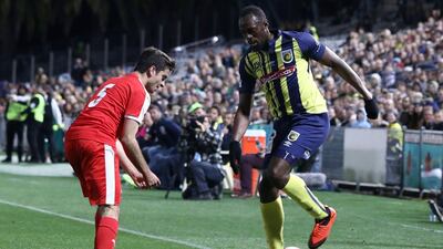 Usain Bolt on the ball during a pre-season friendly for Central Coast Mariners. AFP
