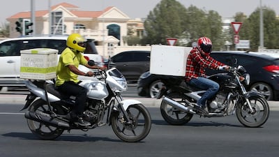 Delivery motorcyclists in Dubai, who will soon be able to pull up at designated roadside areas. Pawan Singh / The National