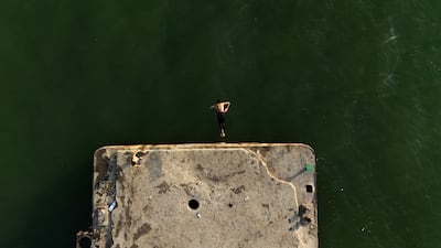 A young Iraqi dives into the Shatt Al-Arab in Basra, amid soaring summer temperatures. AFP