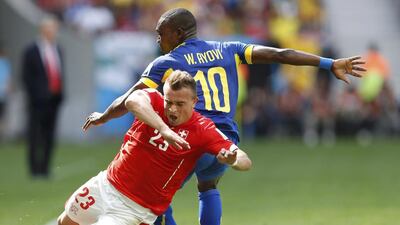 Switzerland's Xherdan Shaqiri, left, trips after being fouled by Ecuador's Walter Ayovi during their 2014 World Cup Group E match on Sunday in Brasilia, Brazil. Ueslei Marcelino / Reuters