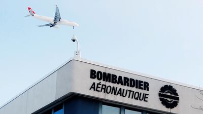 A plane flies over a Bombardier plant in Montreal, Quebec, Canada. Christinne Muschi/Reuters