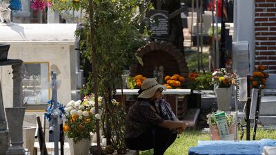 Hundreds of people honour their dead relatives at the Xilotepec Pantheon, in Mexico City. EPA
