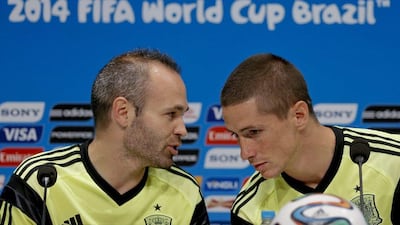 Andres Iniesta and Fernando Torres chat during a press conference on Tuesday ahead of their Wednesday match against Chile at the 2014 World Cup. Juanjo Martin / EPA / June 17, 2014
