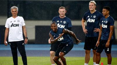 Jose Mourinho, left, put his Manchester United players through a training session at the Olympic Sports Centre in Beijing, China. Thomas Peter / Reuters