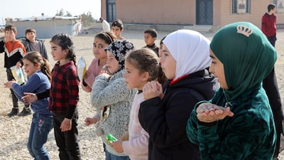 Refugee children dance outside a makeshift shelter in Bekaa Valley, near the border with Syria. EPA