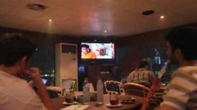 Patrons watch a TV soap opera after iftar at the Marina al Yakhoot coffee shop on the breakwater in Abu Dhabi.