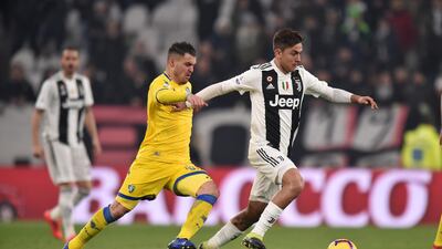 Juevtnus' Paulo Dybala is challenged by Frosinone's Federico Viviani. Getty Images