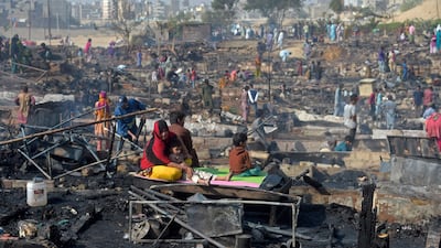 Residents grieve together after they return to the scene of the fire. AFP