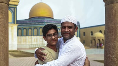 Early morning prayers at the Masjid Bani Hashim mosque. Father and son, Khaleel Mansoori and Arzan, after morning Eid prayers. Victor Besa/The National