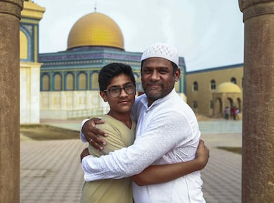 Early morning prayers at the Masjid Bani Hashim mosque. Father and son, Khaleel Mansoori and Arzan, after morning Eid prayers. Victor Besa/The National