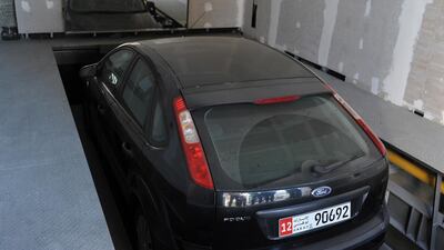 A car is raised to ground level in a building with automated parking in the Sheikha and Marium Saeed Al Rumaithi building, which is being built in Abu Dhabi. Delores Johnson / The National