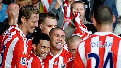 Stoke players gather around Jonathan Walters, centre, who scored Stoke's first in their 2-0 win against Fulham. Laurence Griffiths / Getty Images