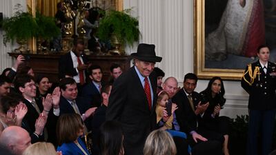 Mr Pelosi takes a bow after being called out during the ceremony. AFP