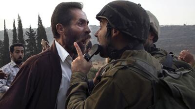 A Palestinian man argues with an Israeli soldier during clashes over an Israeli order to shut down a Palestinian school in the town of as-Sawiyah, south of Nablus in the occupied West Bank on October 15, 2018. AFP