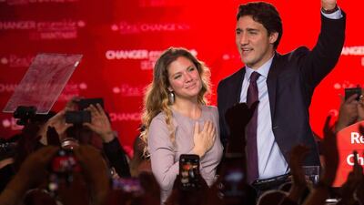Canadian Liberal Party leader Justin Trudeau and his wife Sophie wave on stage in Montreal on October 20, 2015 after winning the general elections. AFP