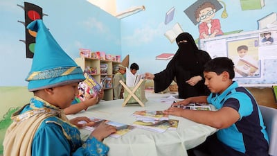Ahmed Sulaiman, left, and Abdullah Mohammed from Grade 5 at the Dadna School for Basic Education in Al Dadna near Fujairah get down to the very serious but fun business of books reading books in their school’s library. Satish Kumar / The National