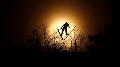 Lukas Runggaldier, of Italy, soars through the air during training for the nordic combined competition at the 2018 Winter Olympics in Pyeongchang. Dmitri Lovetsky / AP Photo