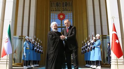 Turkish president Recep Tayyip Erdogan, right, shakes hands with Iranian president Hassan Rouhani at the Presidential Palace in Ankara. Turkish Presidential Press Office / EPA