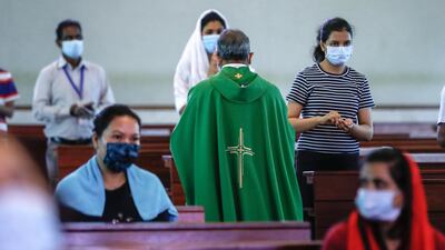 Worshippers maintain social distancing at St Joseph’s Church in Abu Dhabi. Priests and the congregation sanitise their hands before communion.