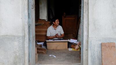 Nepalese woodcarver Indra Kaji Shilpakar works in his workshop in Bhaktapur on the outskirts of Kathmandu. Prakash Mathema / AFP