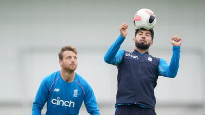 Saqib Mahmood, right, and Jos Butler during training in Leeds. PA