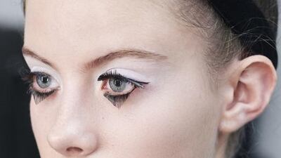 The make-up – a look that was part porcelain doll, part Marie Antoinette – consisted of dark liner smudged into triangles beneath the eyes, coupled with triangular lashes and the lightest dab of rosy blush on the cheeks. Olivier Saillant