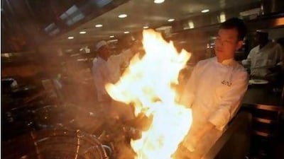 Lee Koh Hua, the chef de cuisine for Hakkasan's restaurant at the Emirates Palace, and his kitchen staff prepare food for guests. Jaime Puebla / The National