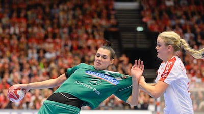 Denmark’s Stine Jorgensen, right, pulls on the jersey of Hungary’s Szandra Szollosi Zacsik during their 2015 Women’s Handball World Championship Group A match. Jonathan Nackstrand / AFP Photo