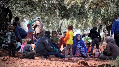 Mustafa Farhan sits with his sons and children from other displaced families on Harem mountain near Al Khair camp in Idlib, Syria, on May 4, 2019. Hashem Dardowra for The National