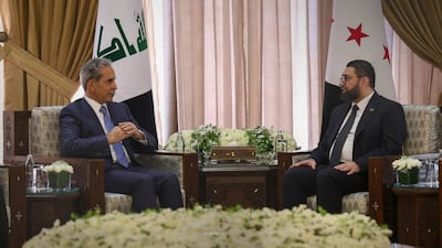 Syrian Justice Minister Mazhar Al Wais, right, and the head of Iraq’s Supreme Judicial Council, Faiq Zaidan, hold talks in Damascus. Sana