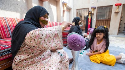 An Emirati women doing talli, a traditional Emirati handicraft that is taught at the centre.