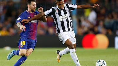 Barcelona's Lionel Messi, left, and Juventus' Alex Sandro vie for the ball during a Champions League group D soccer match between FC Barcelona and Juventus at the Camp Nou stadium in Barcelona, Spain