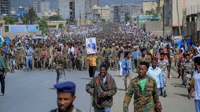 Captured members of the Ethiopian National Defence Force are marched through the streets to prison under guard by Tigray Forces in July in Mekelle, Tigray. AP