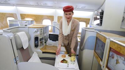A flight attendant serves a meal at the executive suite cabin of an Emirates Airbus A380. Noah Seelam / AFP