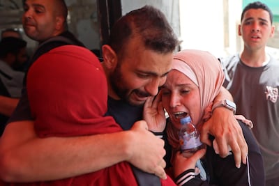 Relatives weep near the body of Ibrahim Rayyan, a Palestinian who was reportedly killed in an Israeli strike at the Al-Aqsa hospital in Deir Al Balah, central Gaza Strip. AFP