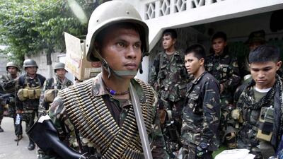 Government troops in Zamboanga, Philippines, yesterday prepare to fight Muslim rebels who stormed several coastal communities. Bullit Marquez / AP Photo