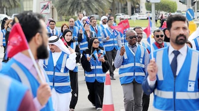 Adnoc employees and people participating in the march of Special Olympics “Flame of Hope” at the Founder’s Memorial in Abu Dhabi. Pawan Singh / The National