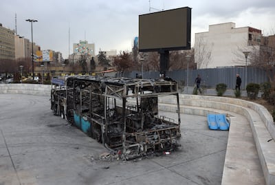 The wreckage of a burnt-out public bus in Tehran after public protests. EPA