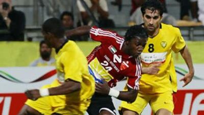 Ah Ahli's Ismael El-Hamadi battles for a loose ball as Ali Mahmoud of Al Wasl, right, watches during Friday's game.