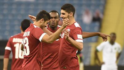 Qatar’s Ibrahim Majid (L) celebrates with his teammates after scoring a goal against Saudi Arabia’s national team during the 22nd Gulf Cup football match at the King Fahad International stadium in Riyadh on November 13, 2014. AFP PHOTO/FAYEZ NURELDINE