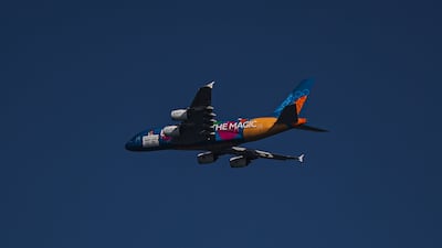 An Emirates A380 with Expo 2020 livery flying over Jumeirah Beach and Sheikh Zayed Road in Dubai, on October 13, 2021. EPA